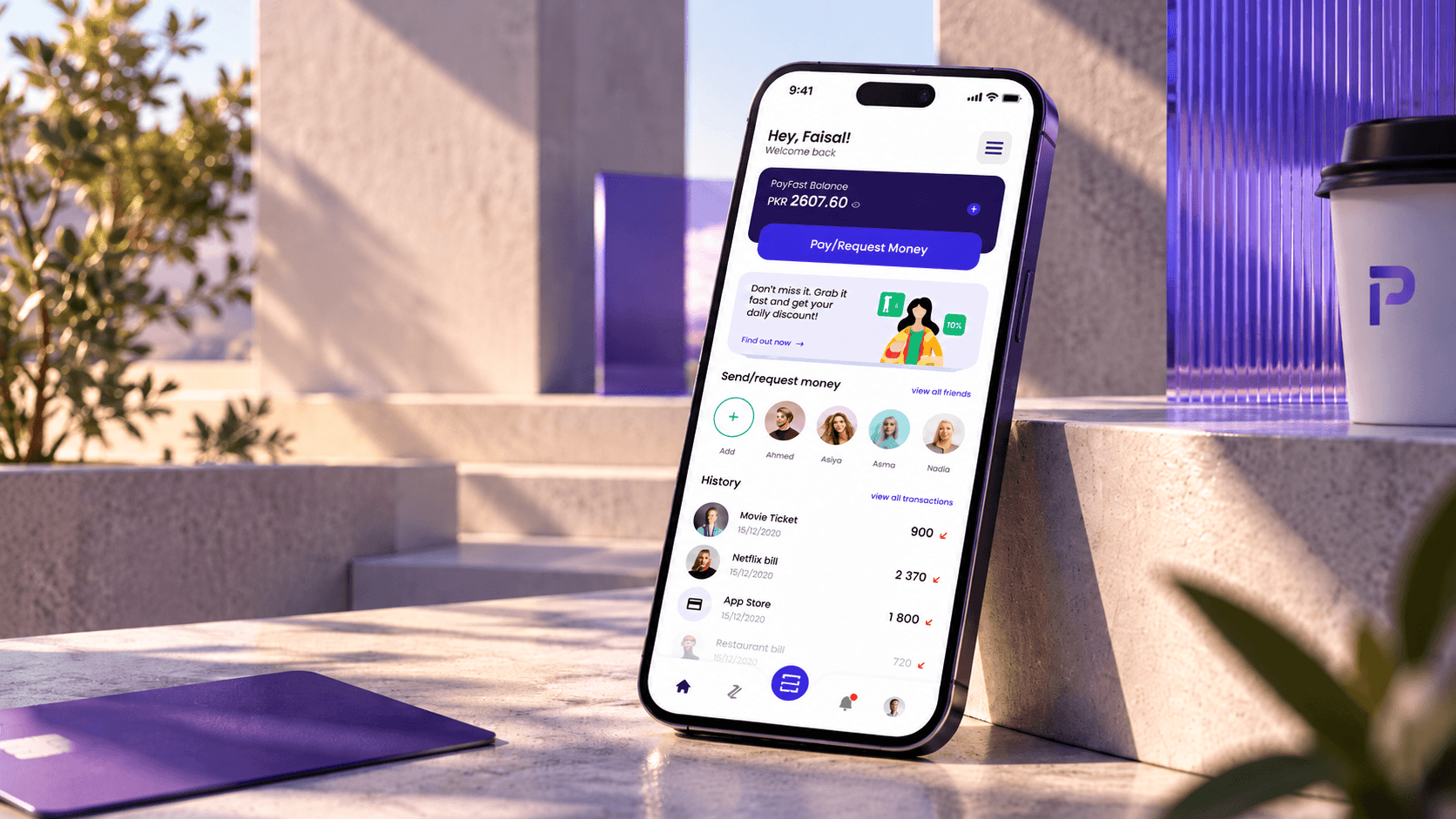 An iPhone leaning on a sunlit stone step showing the PayFast home screen, with the rupee balance, a Pay/Request Money button, friends and recent payments, beside an indigo card, a coffee cup with the PayFast mark and indigo glass panels